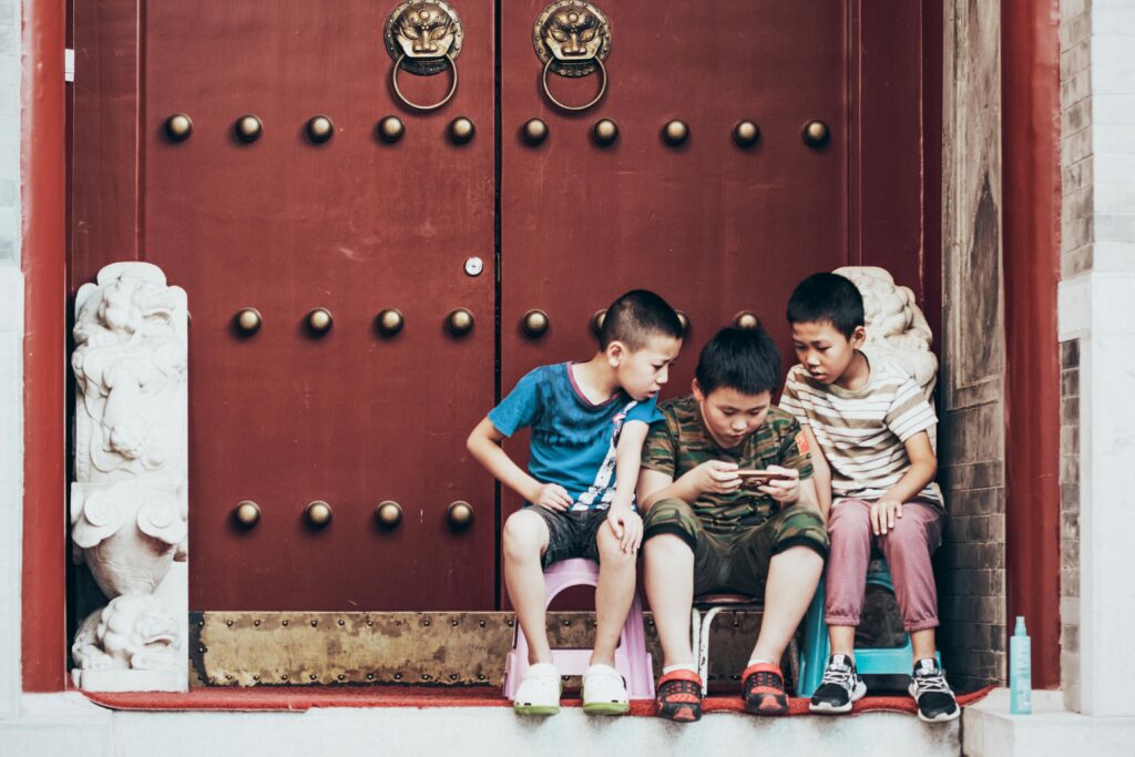 An image of children playing on a phone